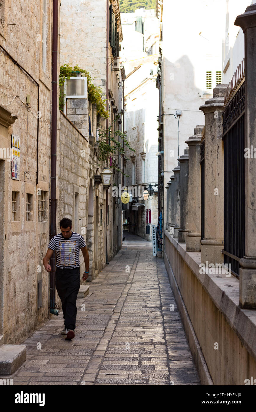 A man walks down a laneway in Old City, Dubrovnik Stock Photo