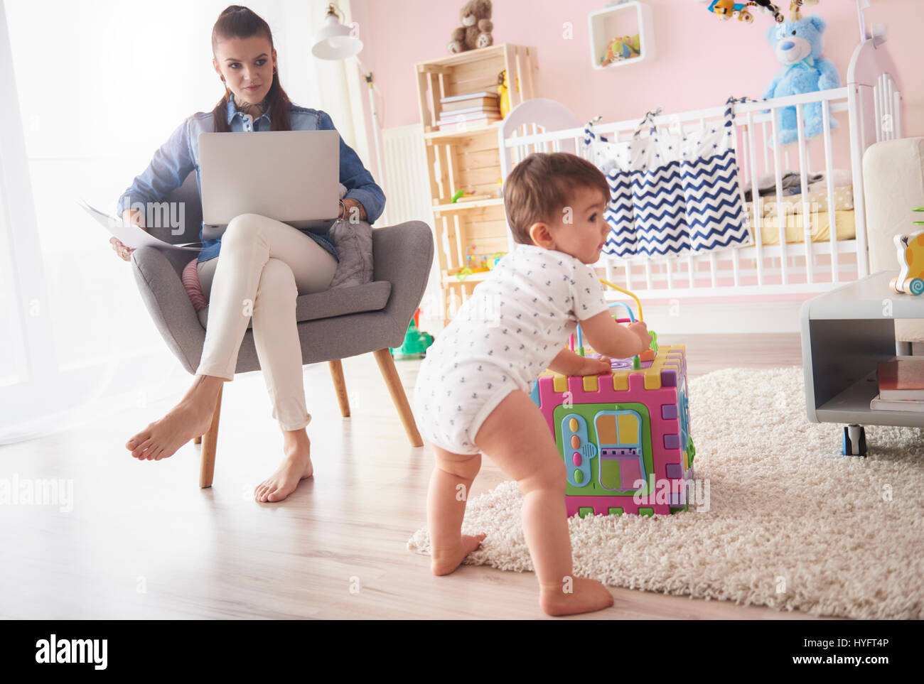 Mother keeping an eye on baby boy Stock Photo Alamy
