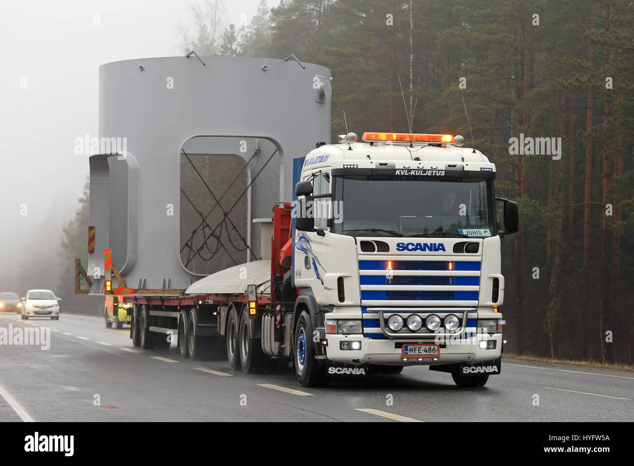 FORSSA, FINLAND - APRIL 2, 2017: Scania semi oversize transport of an industrial object by KVL Kuljetus moves along road on a foggy day. Behind the ve Stock Photo