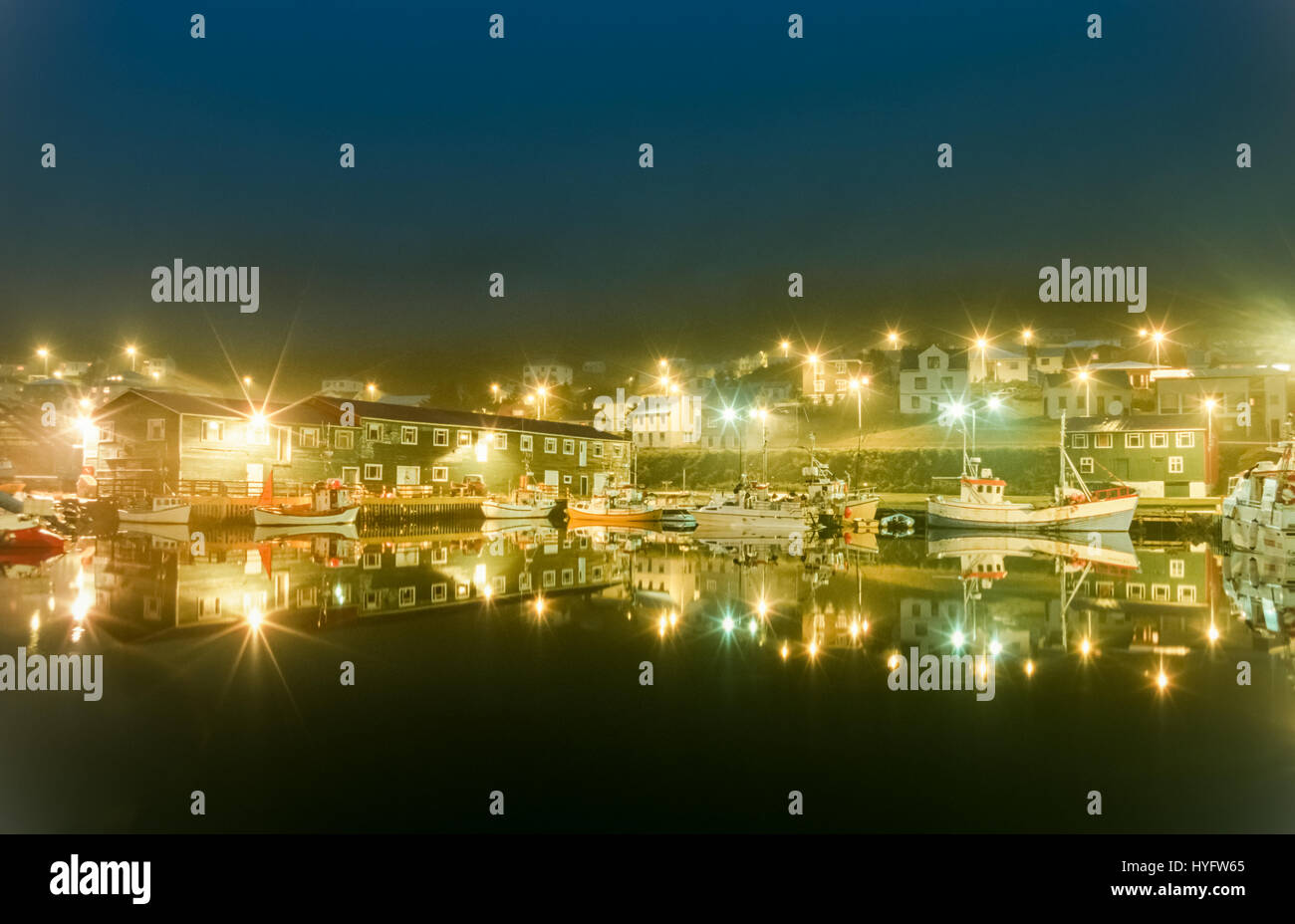 Harbor fishing boats at night with beautiful lights. Siglufjordur, Iceland. Stock Photo