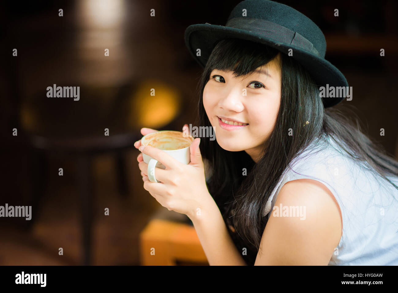 Asian young woman holding coffee cup smiling looking at camera, Close ...