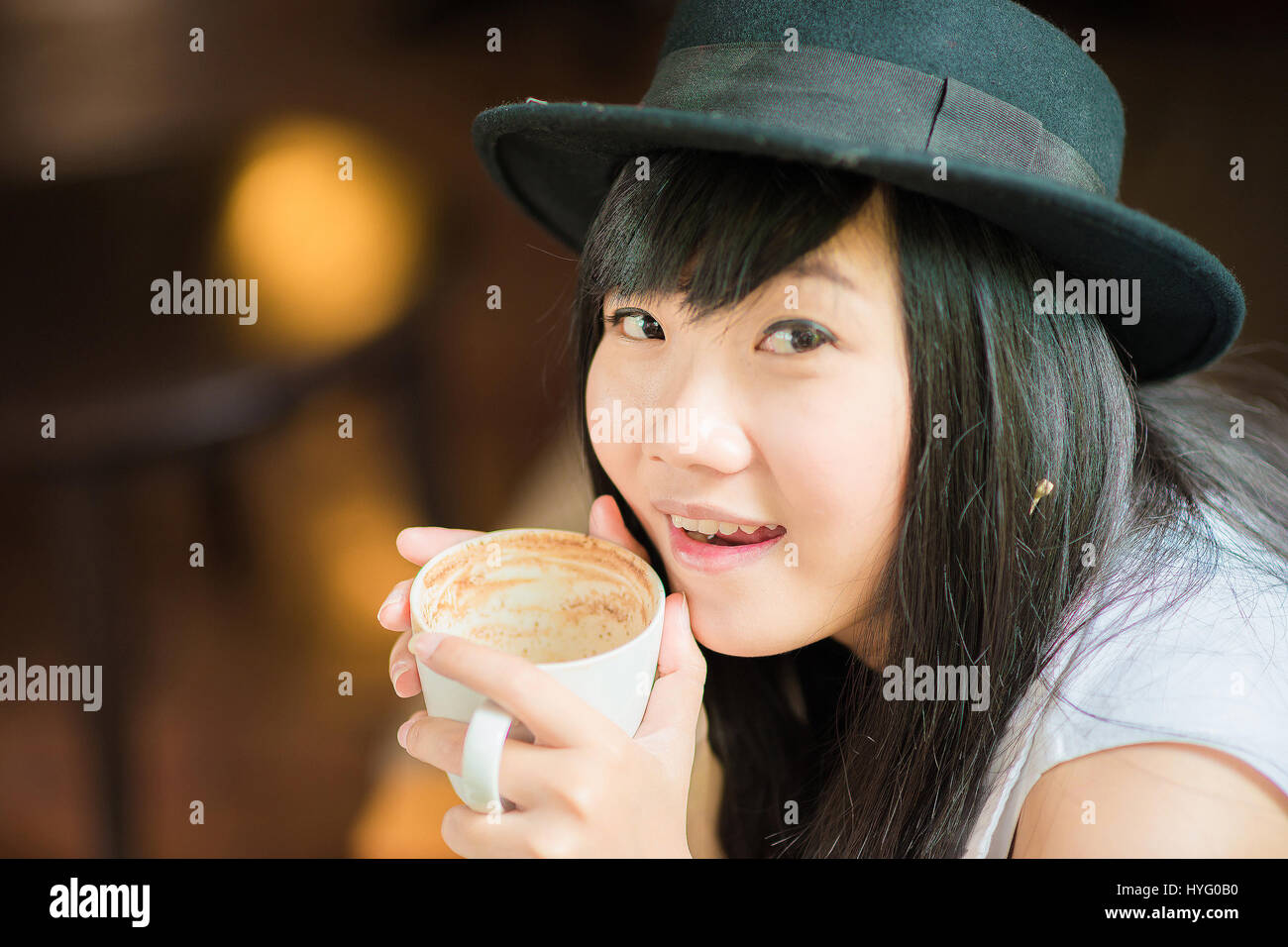 Asian young woman holding coffee cup smiling looking at camera, Close ...
