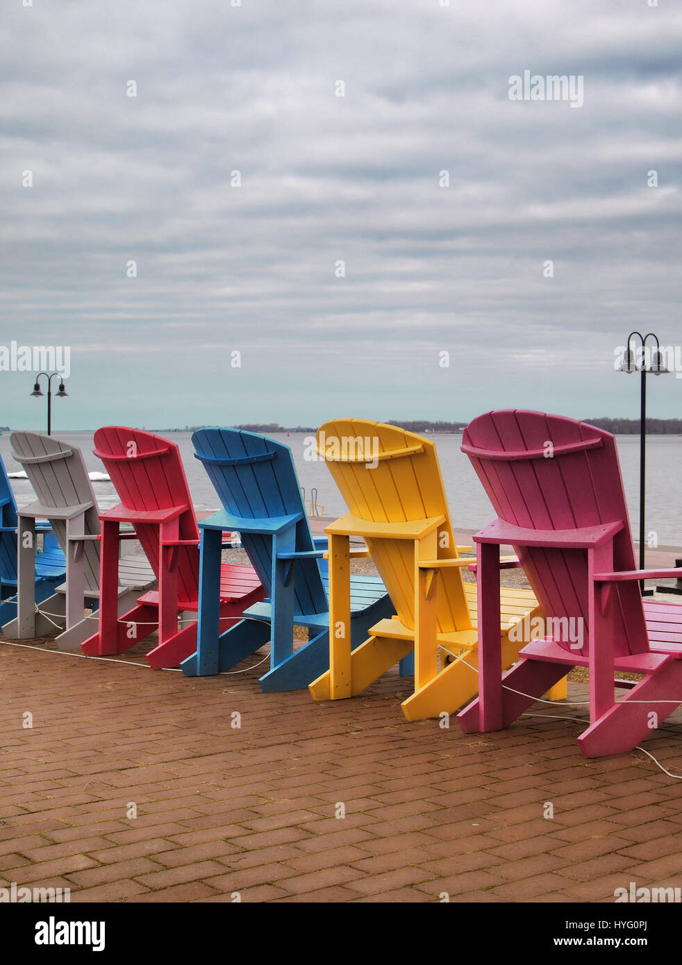 Adirondack chairs on the shore of The Saint Lawrence River facing The Thousand Islands in Clayton, New York Stock Photo