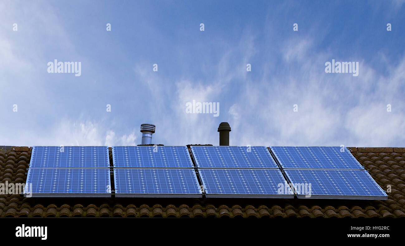 Solar Panels On Sloped Roof Top With Blue Sky In Background Stoke On Trent Staffordshire United Kingdom Renewable Energy Solar Cells On House Roof Stock Photo Alamy