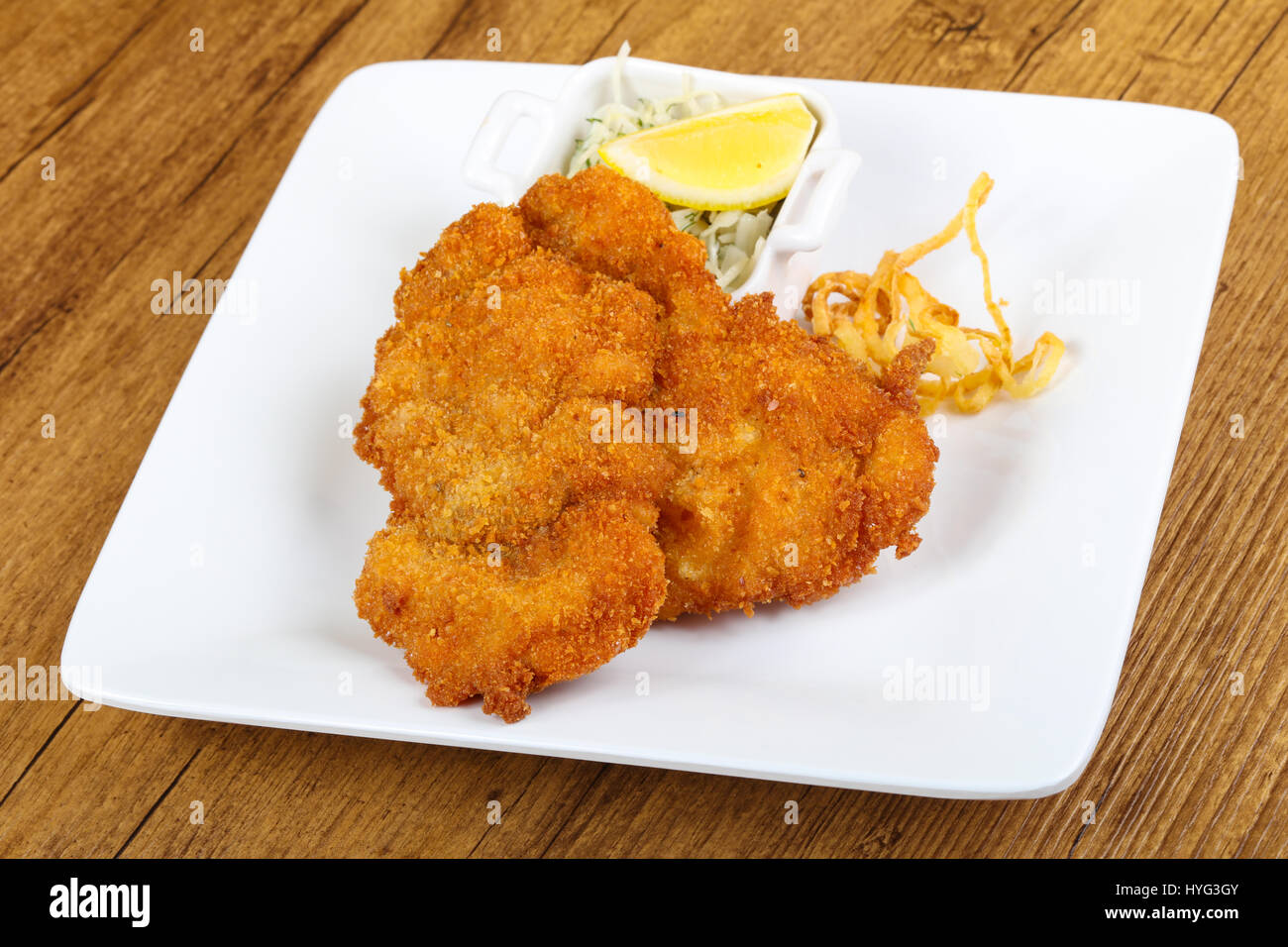 Czech cuisine - schnitzel with cabbage and lemon Stock Photo - Alamy