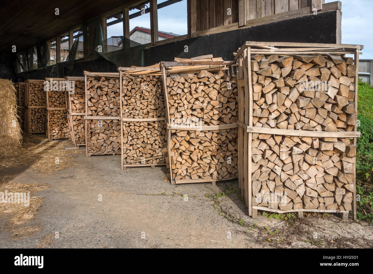 Firewood racks in a barn Stock Photo