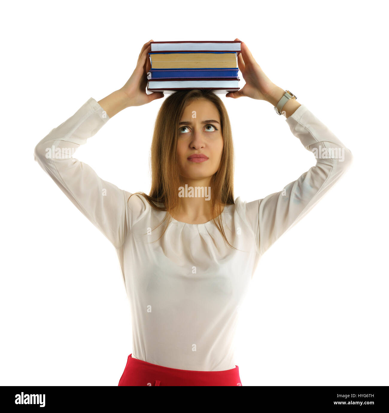 Cute young student girl holds books stack on head Stock Photo - Alamy