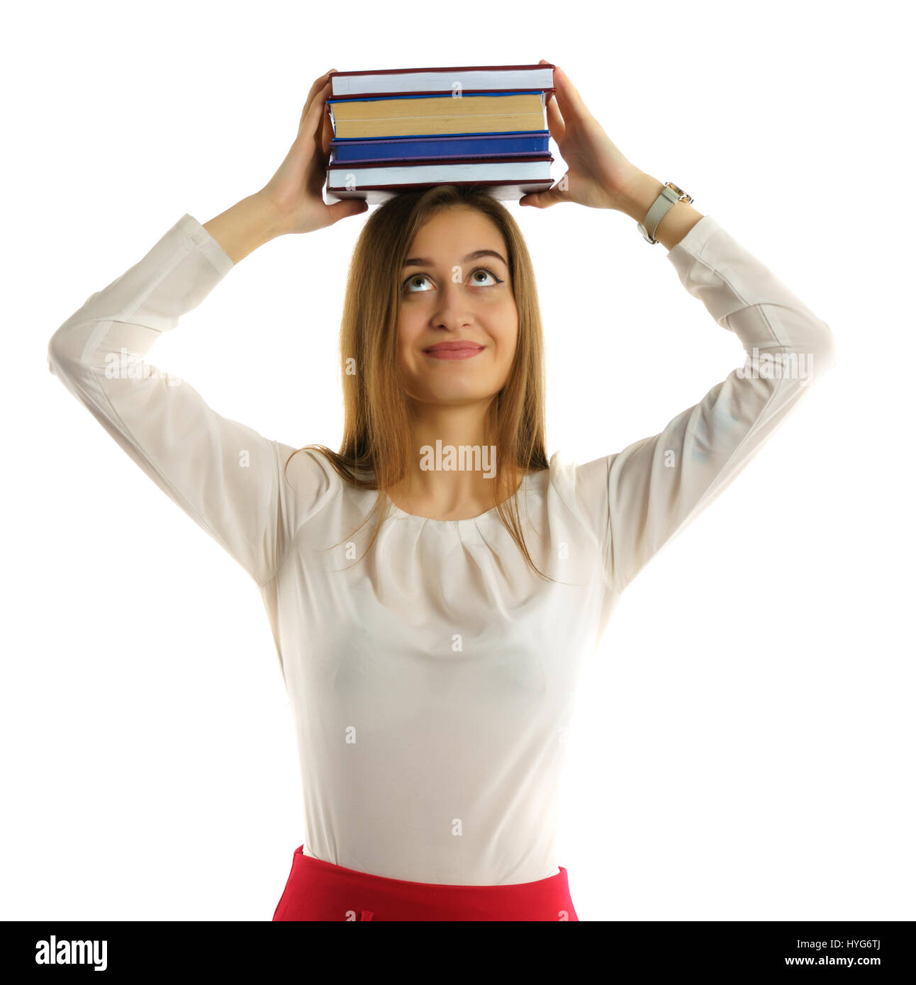Cute young student girl holds books stack on head Stock Photo - Alamy
