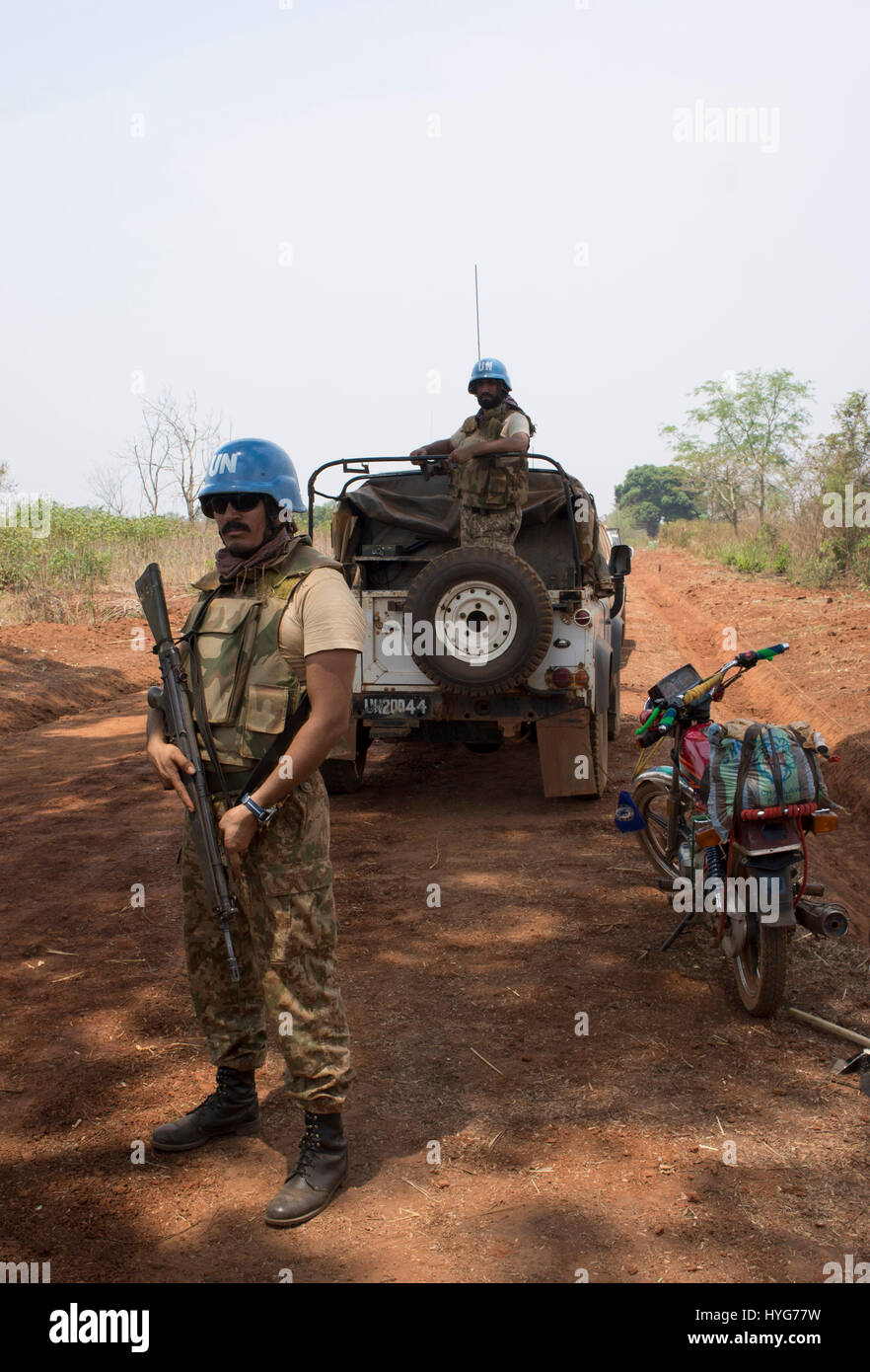 Pakistani soldiers in a United Nations peacekeeping force stand guard over a road construction crew in the Central African Republic Stock Photo