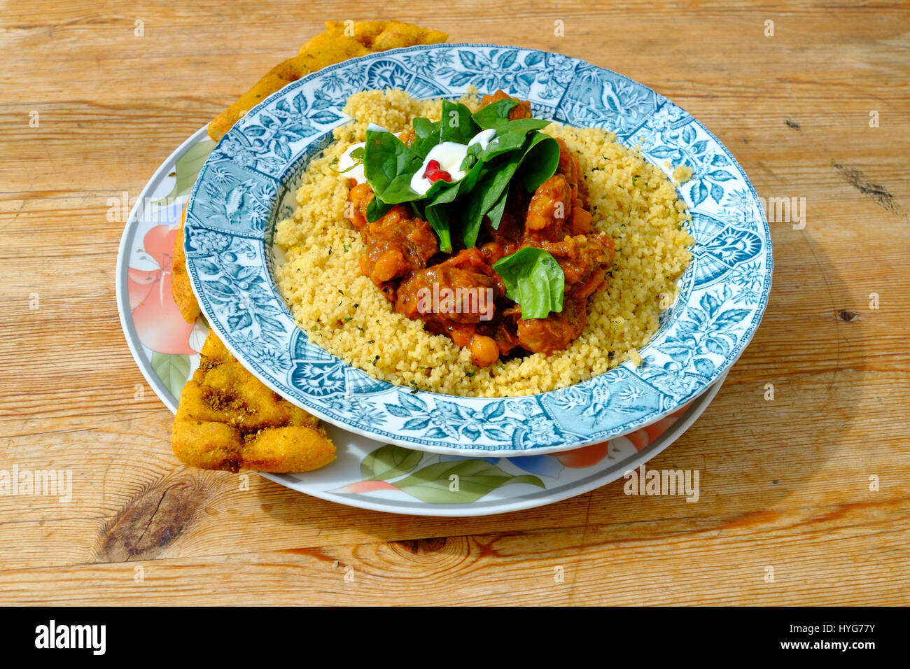 Café lunch Moroccan Lamb Tagine with herby Cous Cous served with toasted flat bread Stock Photo