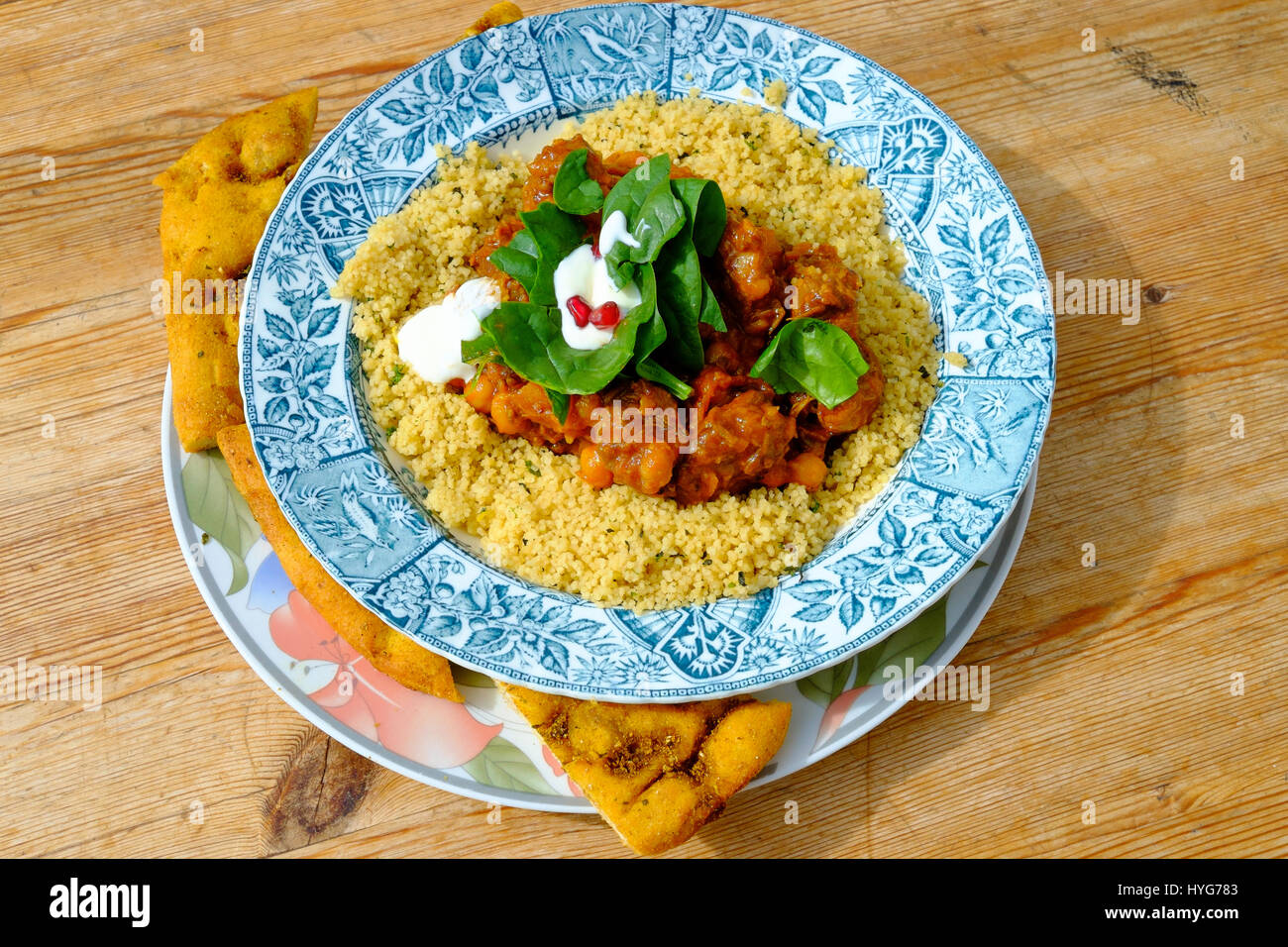 Café lunch Moroccan Lamb Tagine with herby Cous Cous served with toasted flat bread Stock Photo