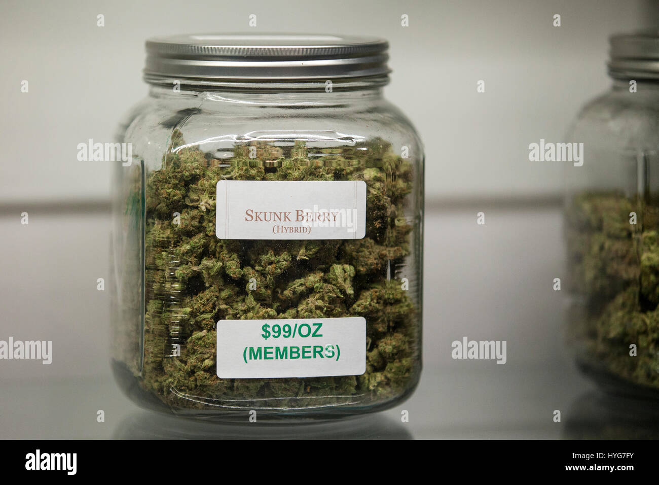 Glass jars full of marijuana buds on display and for sale at a