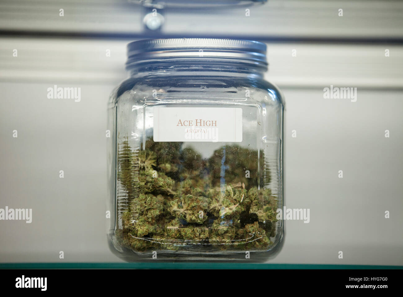Glass jars full of marijuana buds on display and for sale at a dispensary in Colorado Stock