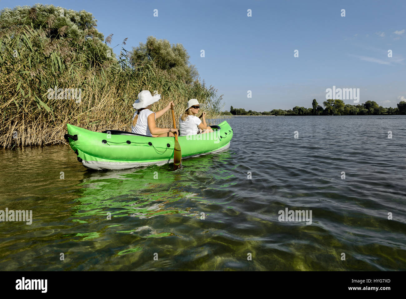 Woman paddling in kayak on tranquil lake river scenery Stock Photo