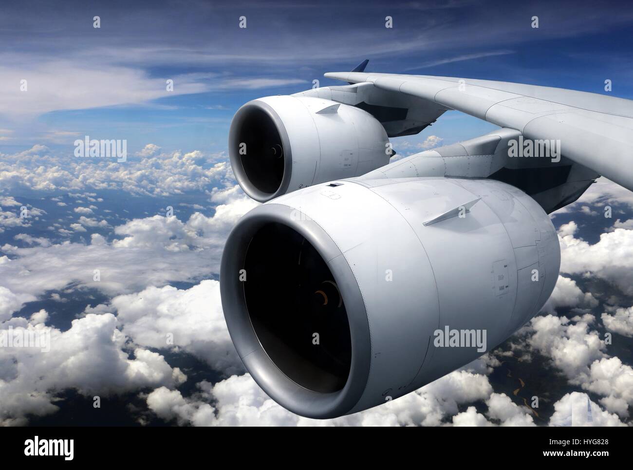 Airplane turbine engine from window view with cloudy sky Stock Photo