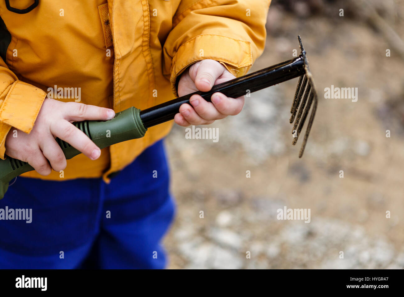 young boy play with rake - outdoors, yard Stock Photo - Alamy