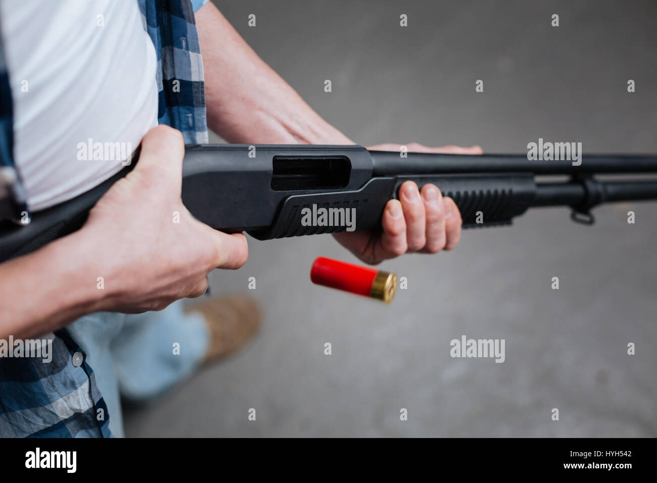 Red riffle bullet dropping out of the gun Stock Photo Alamy