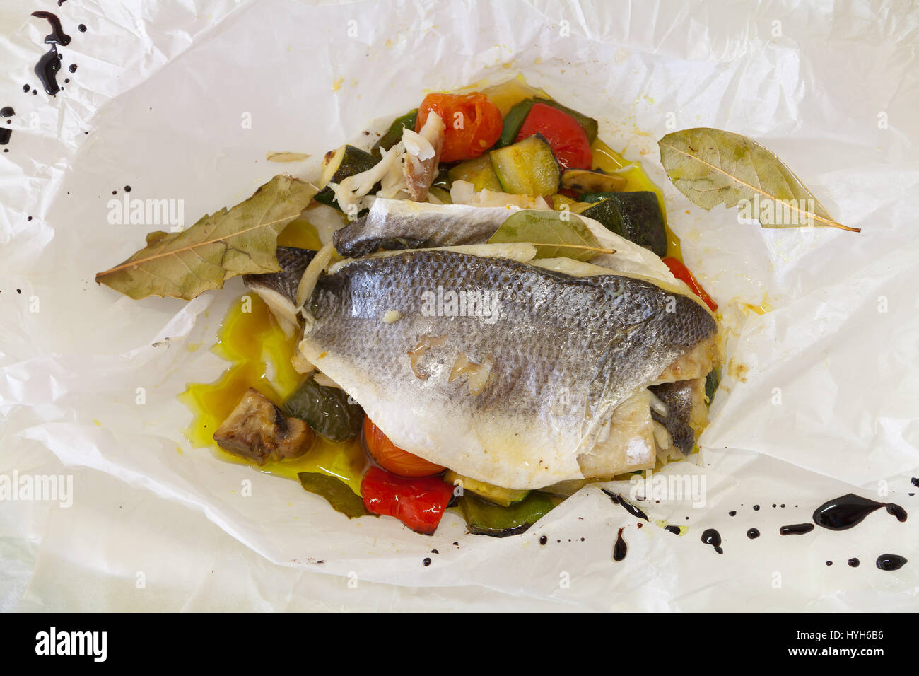 Sea bream with vegetables in a paper bag Stock Photo