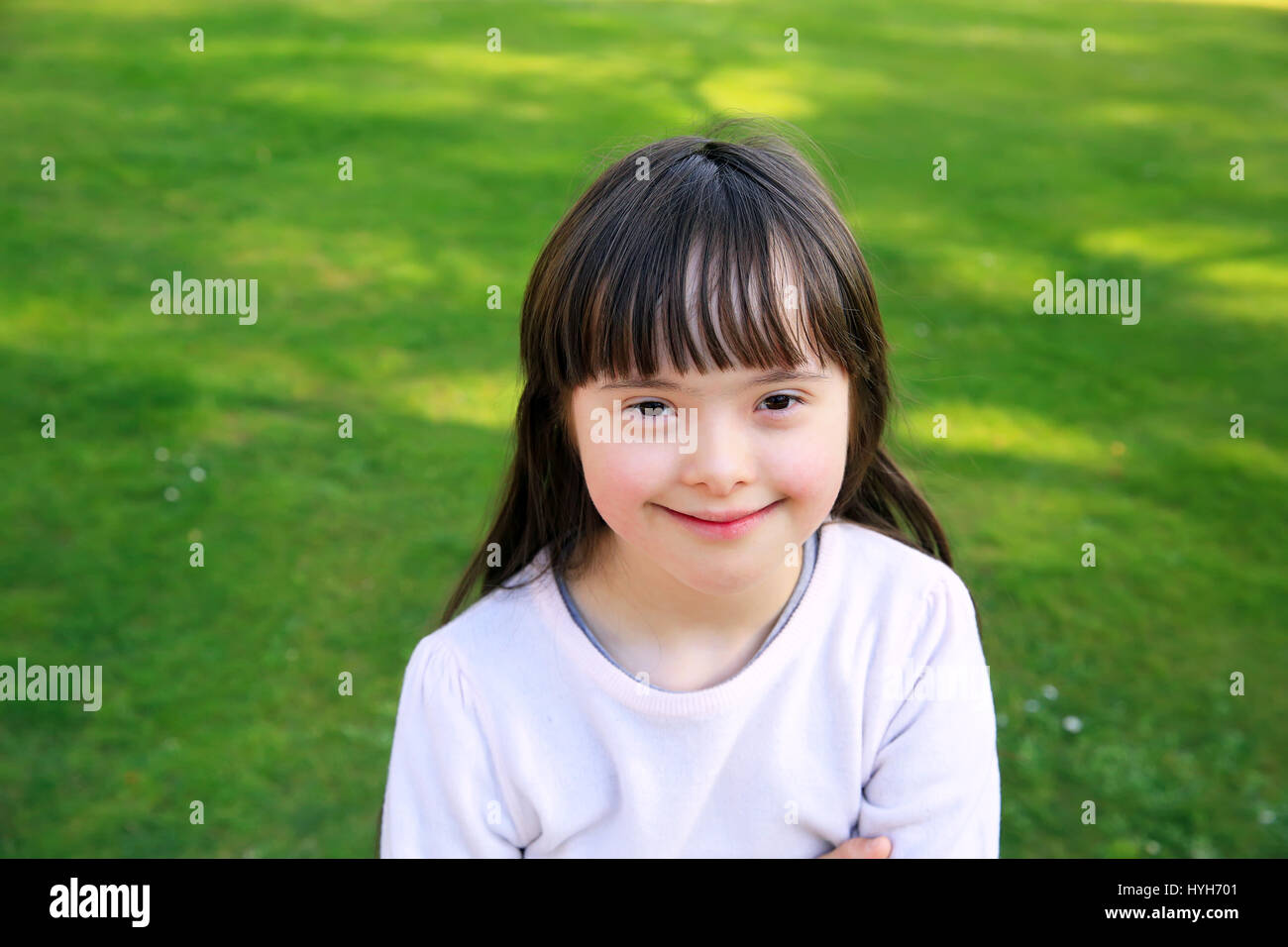 Portrait of little girl smiling outside Stock Photo - Alamy
