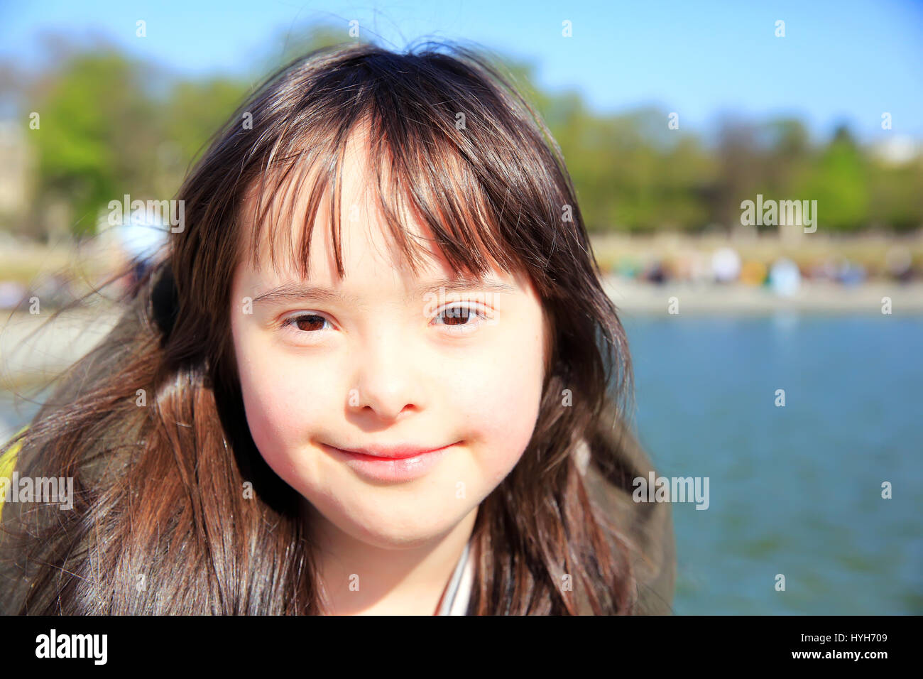 Portrait of little girl smiling outside Stock Photo - Alamy