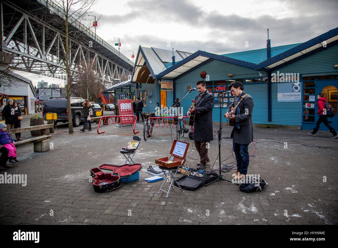 Young guitarists and singer performing outdoors, Granville Island, Vancouver, British Columbia, Canada Stock Photo