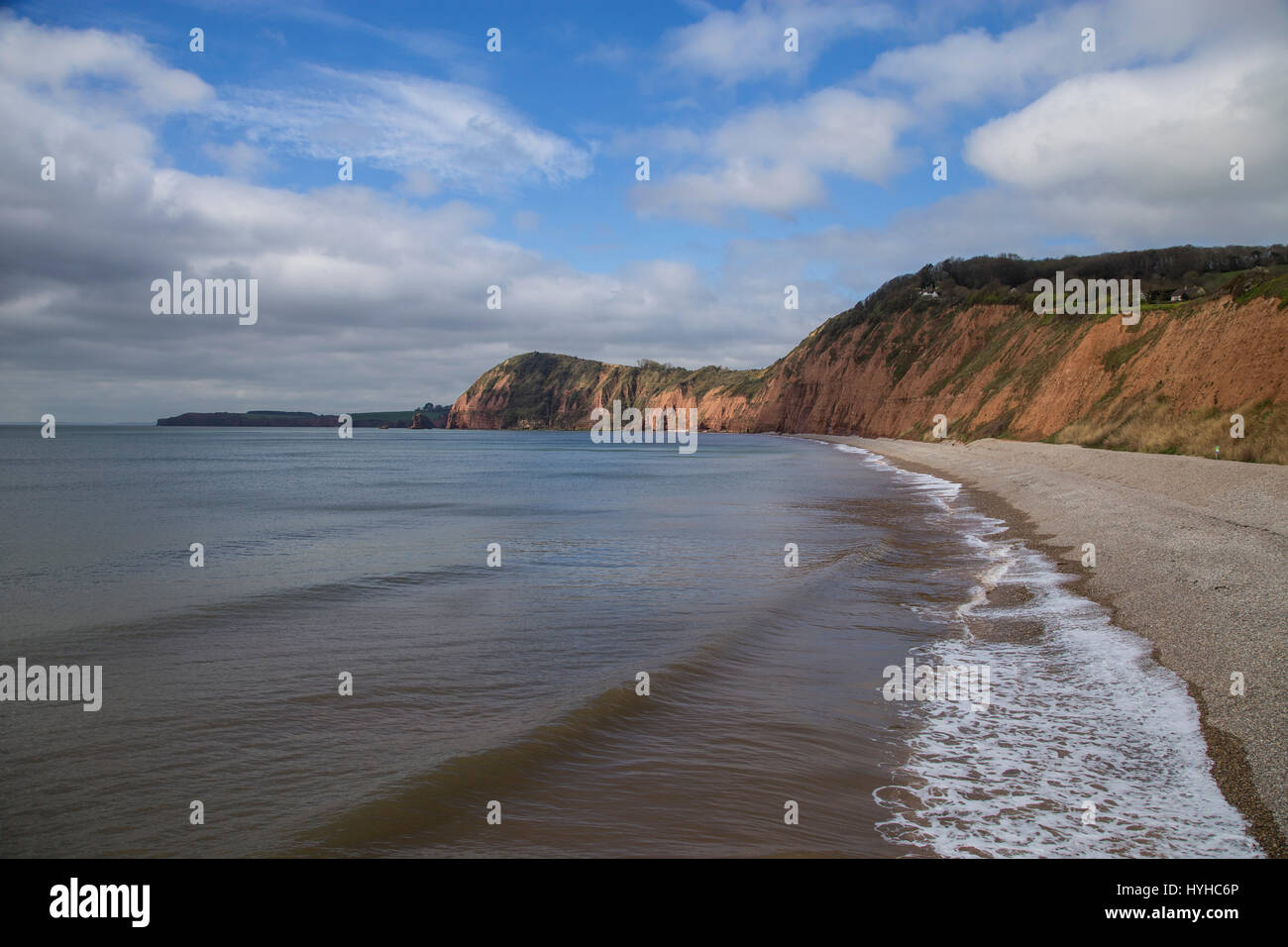 View of the west beach at Sidmouth,Devon, with shingle beach and red sandstone cliffs Stock Photo
