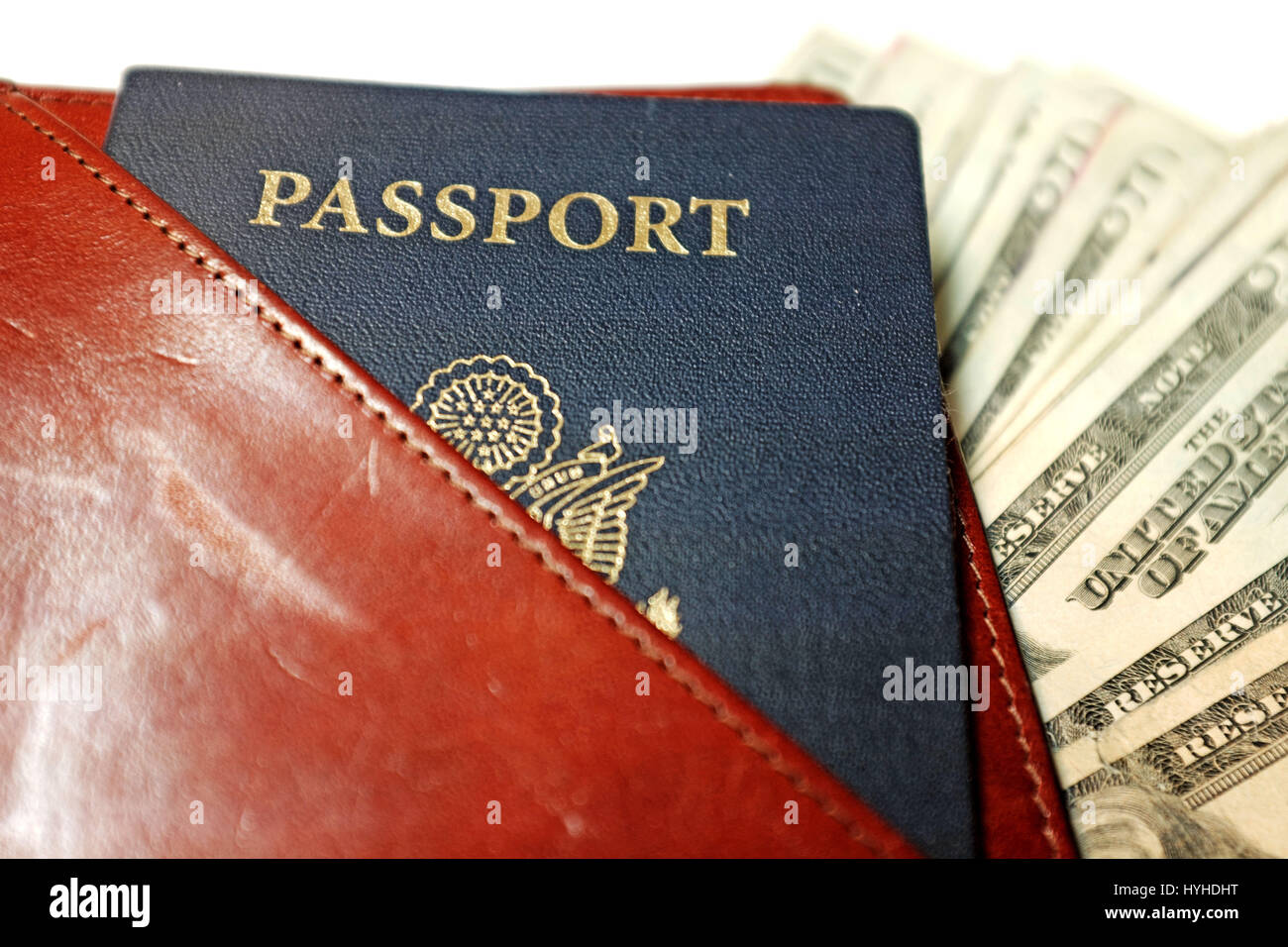 USA passport with US currency in leather travel document holder Stock Photo