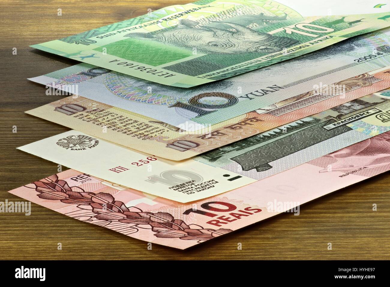 banknotes of the BRICS states on wooden background Stock Photo
