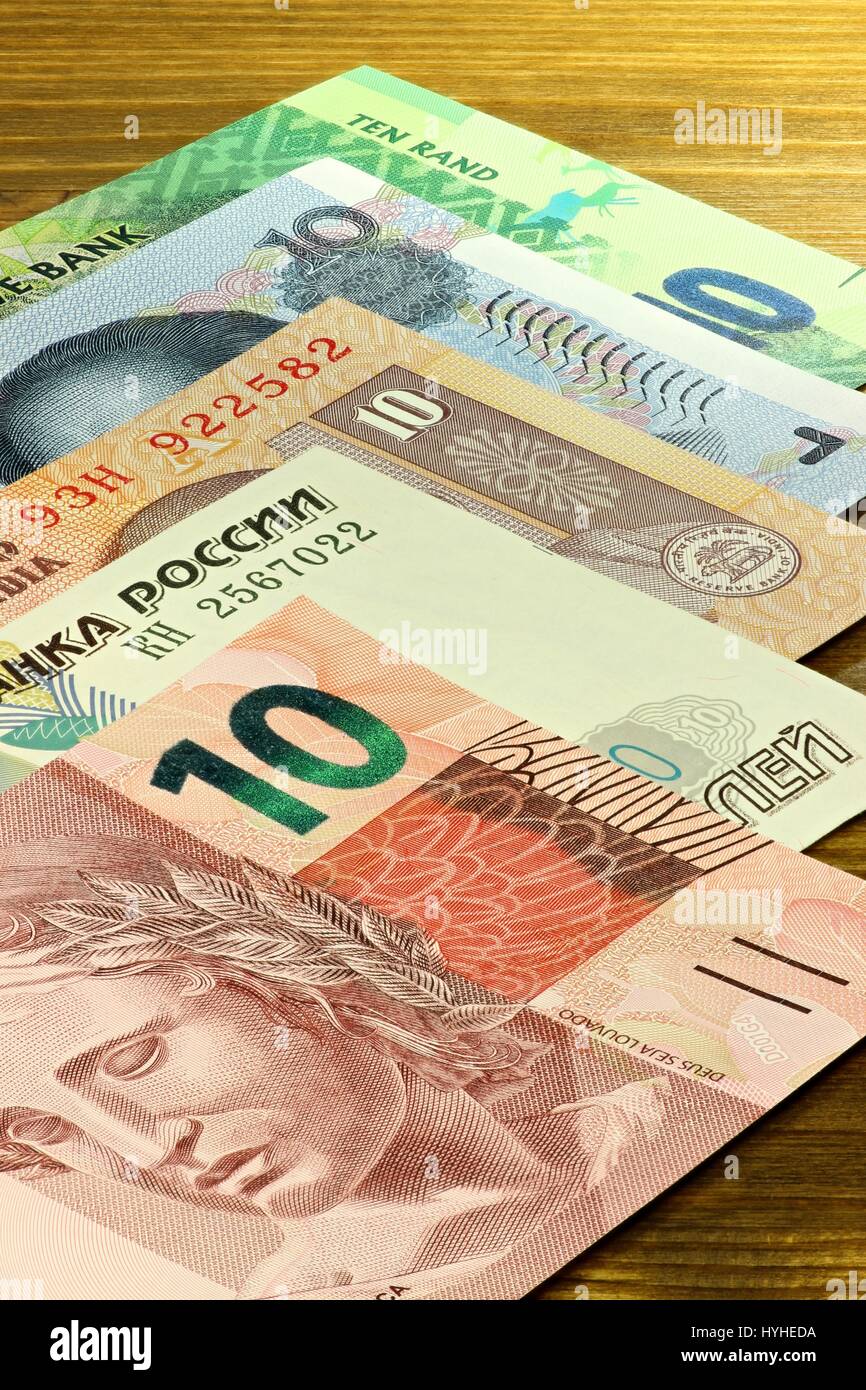 banknotes of the BRICS states on wooden background Stock Photo
