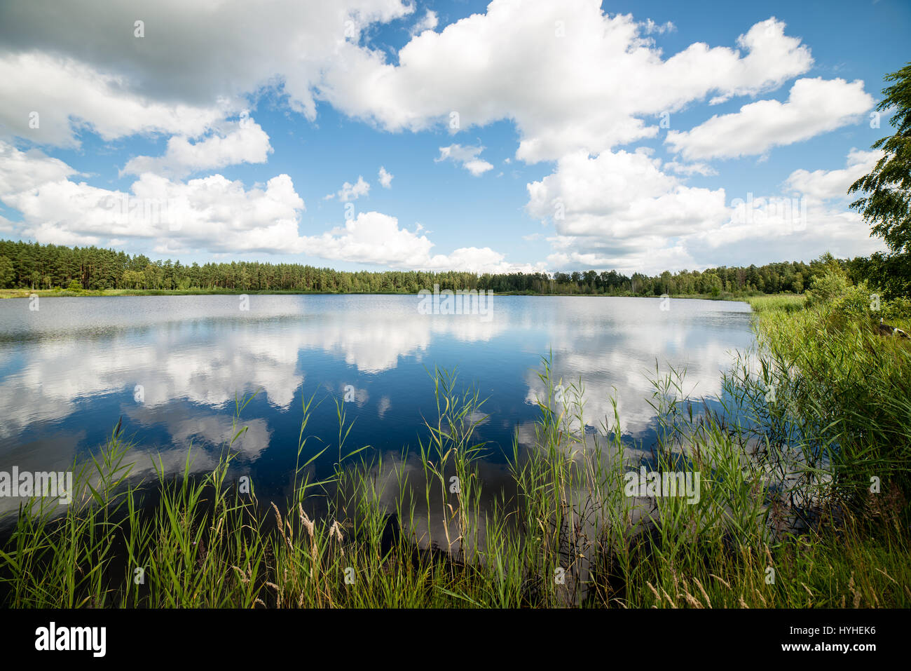 reflections in the lake water at sunrise with clouds and dramatic ...