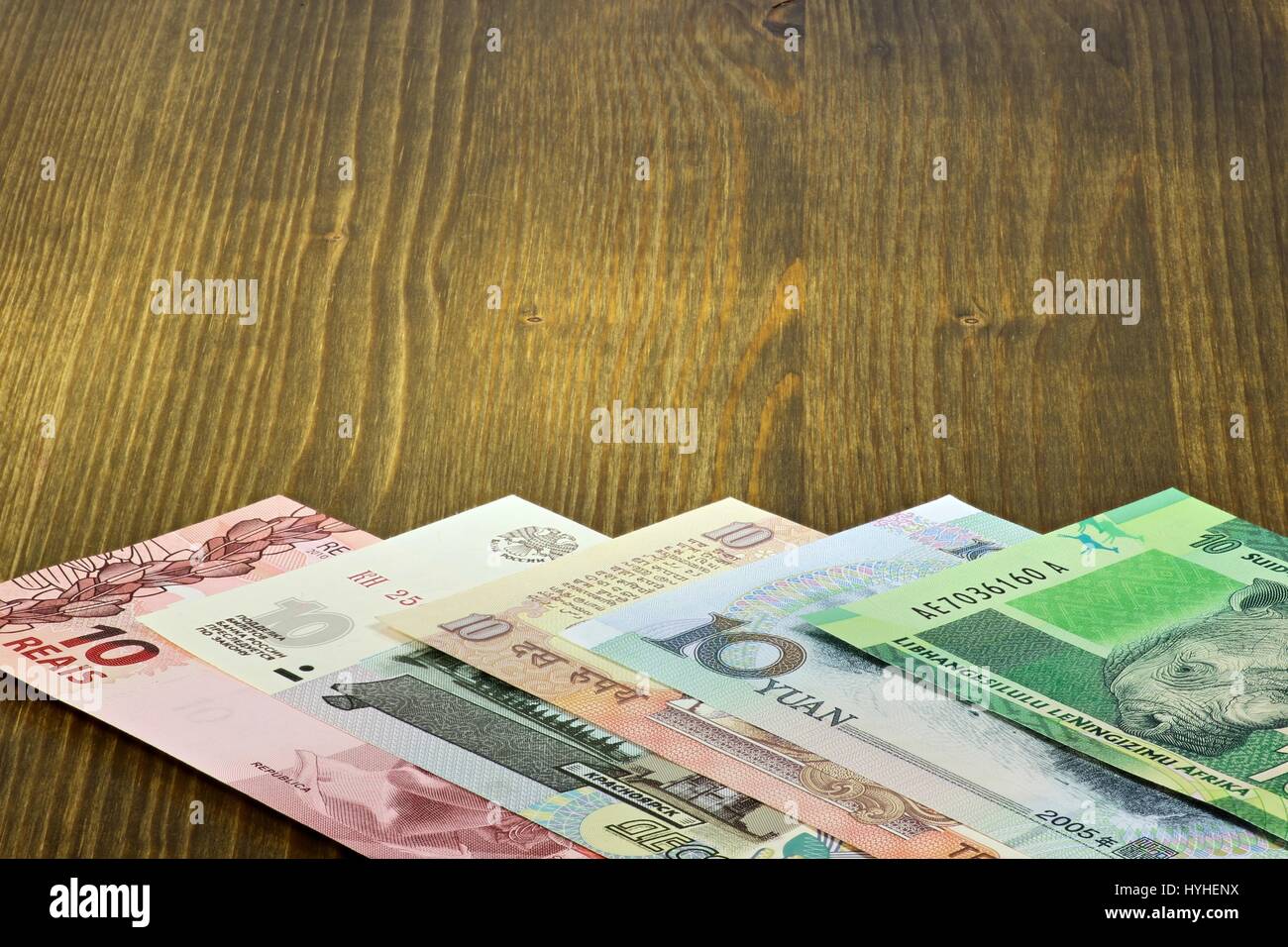 banknotes of the BRICS states on wooden background Stock Photo