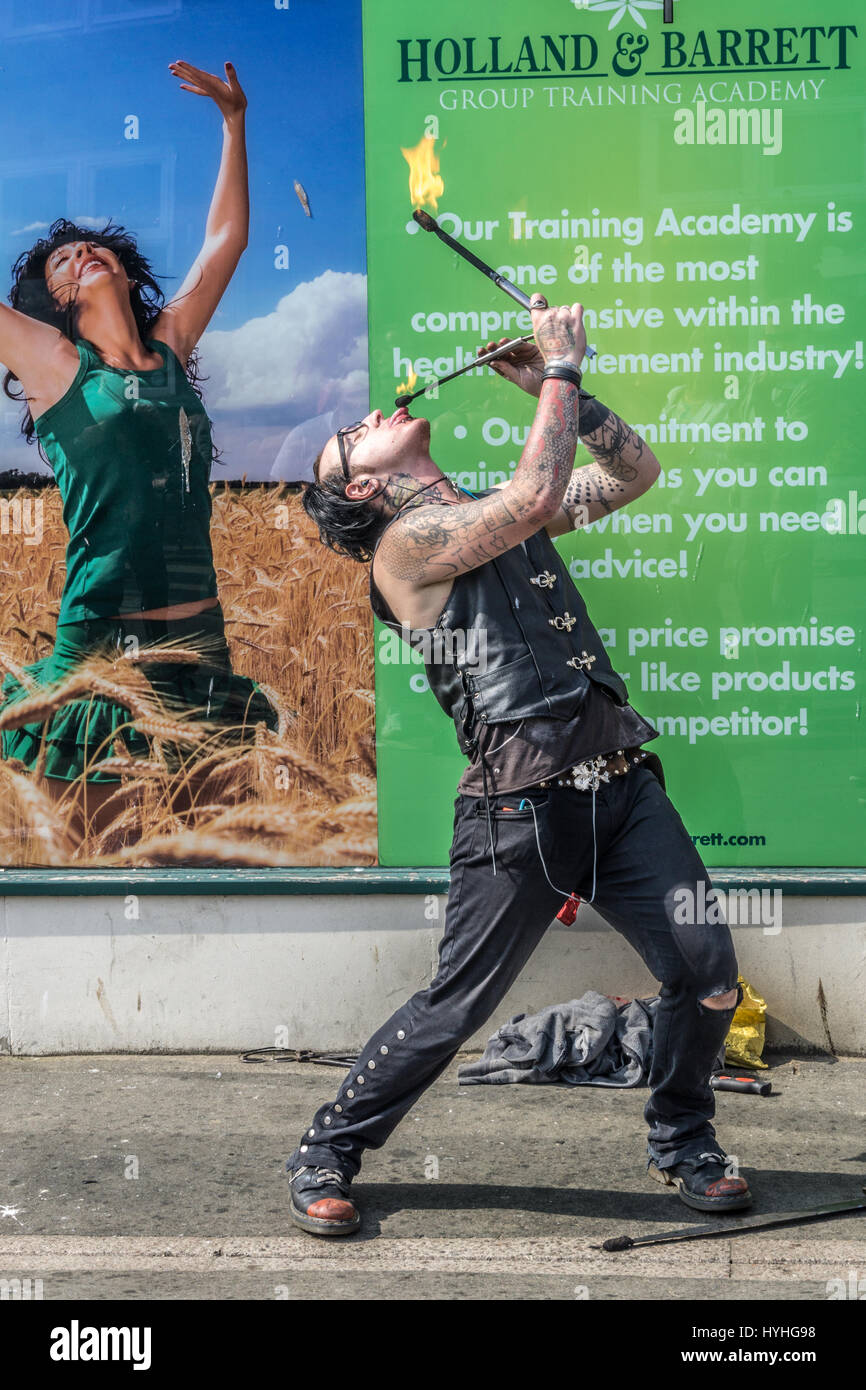 Street artist performing fire eating on a Whitby Street. Stock Photo