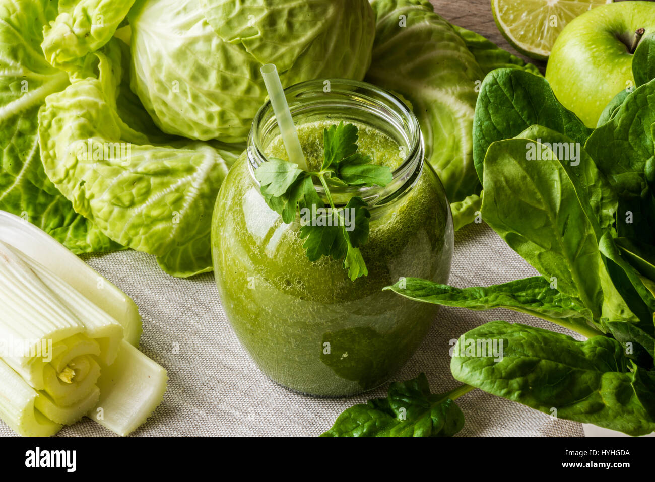 Detox diet. Green smoothie with different vegetables on wooden ...