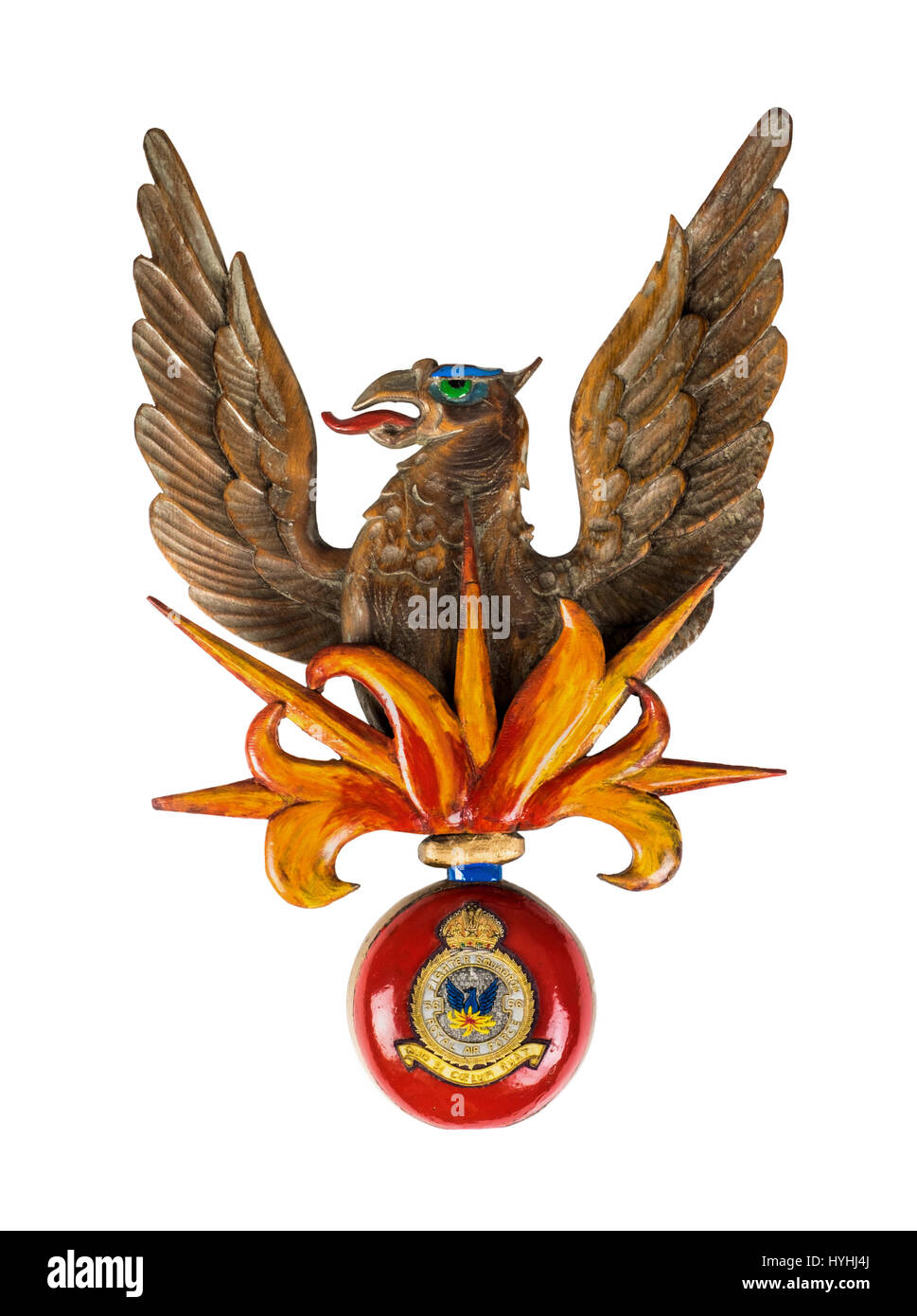 Carved phoenix emblem of No 56 Fighter Squadron of the Royal Air Force, with a burst of flames beneath and a WW2 cloth squadron blazer badge below. Stock Photo