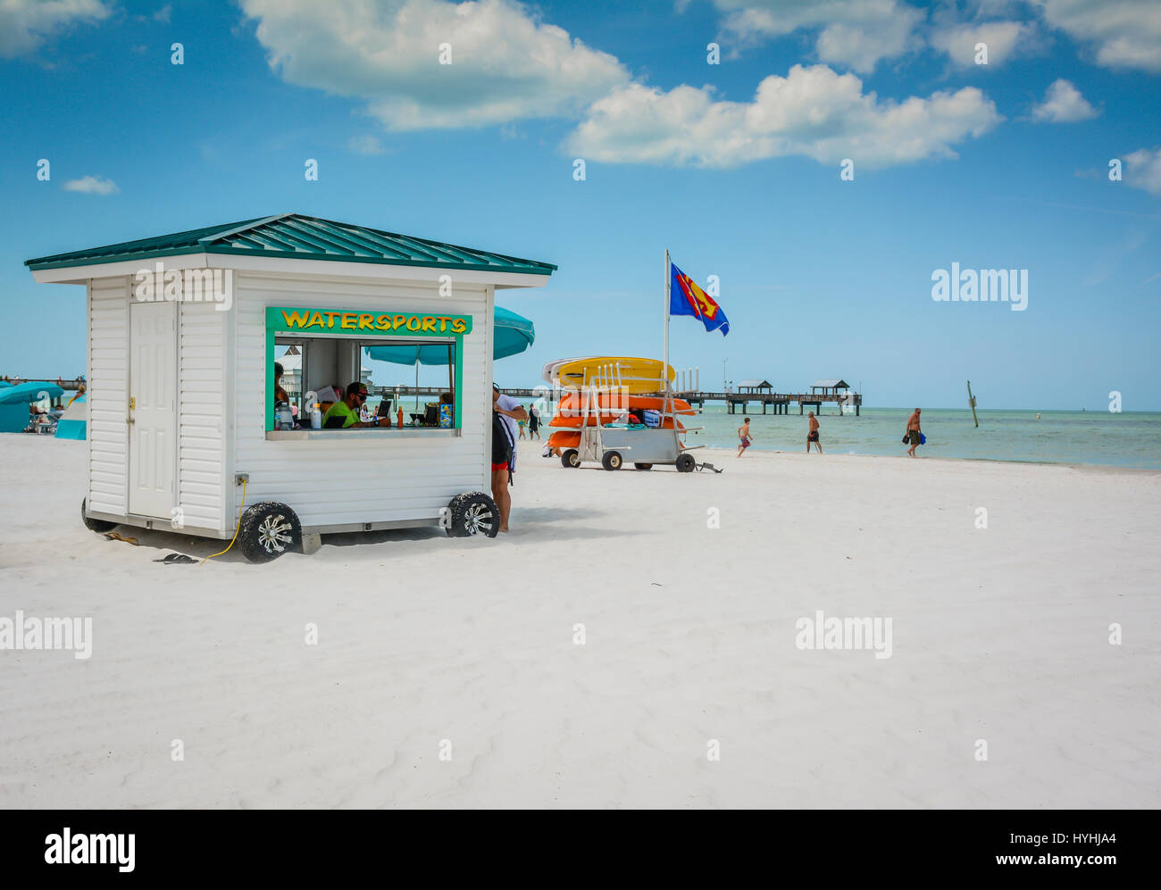 Popular white sand beach on Clearwater Beach, Florida, a kayak rental hut and ATV near the pier