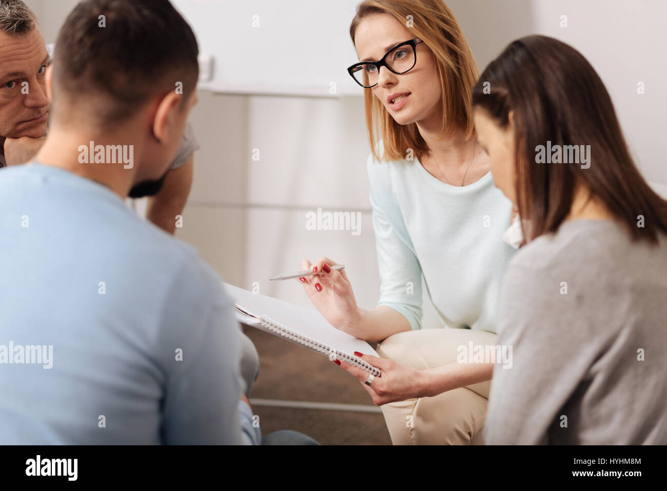 Group of workers discussing important questions Stock Photo - Alamy