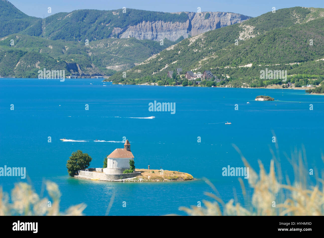 France, Haute-Alpes, Lac de Serre-Ponçon, the island and the chapel Saint Michel in summer Stock Photo
