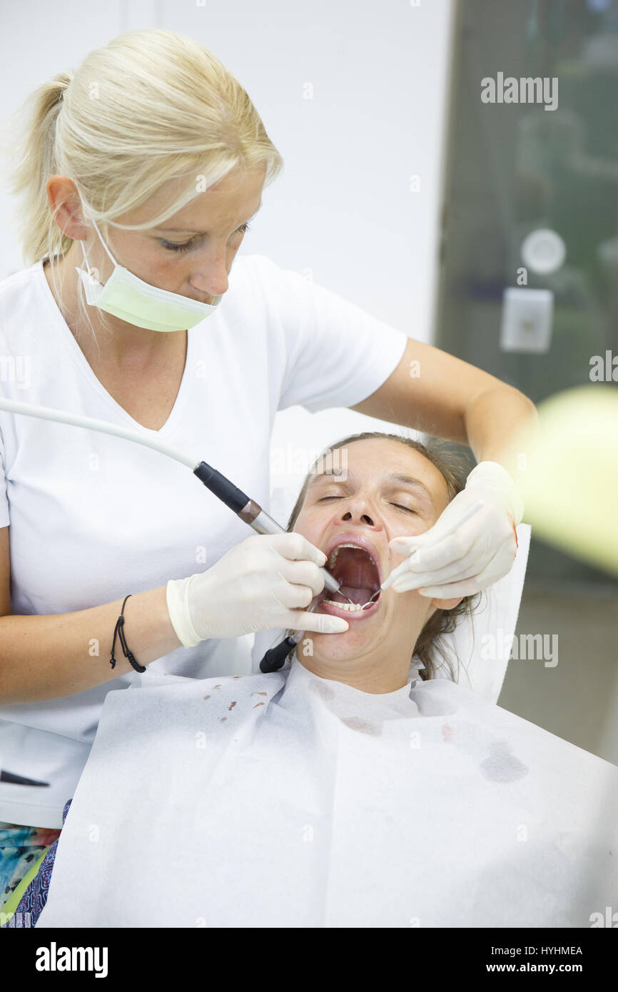 Patient and her dentist, doing a comprehensive examination on regular