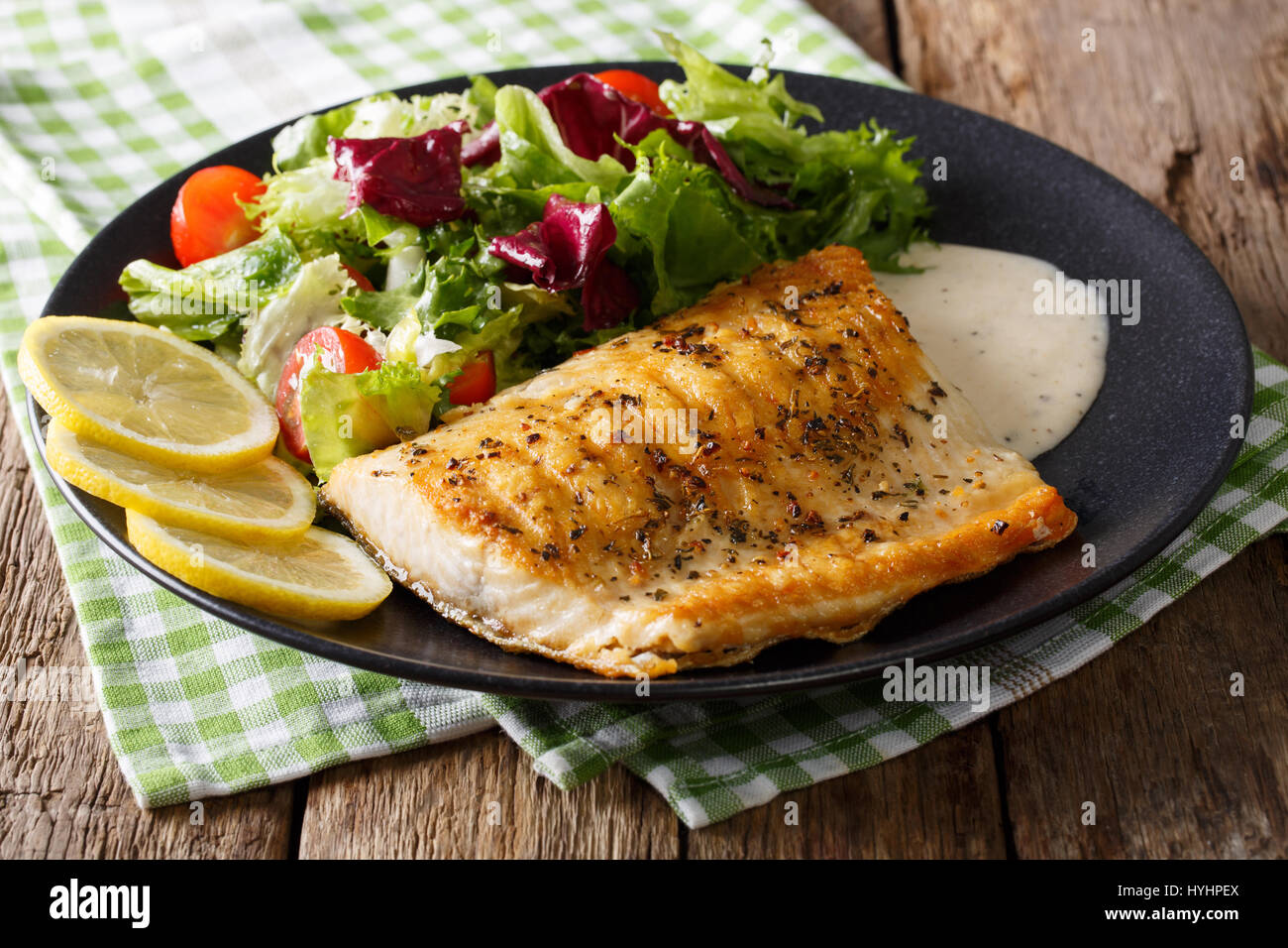 Grilled Arctic char fillet with mixed salad and sauce on a plate close-up.  horizontal Stock Photo - Alamy