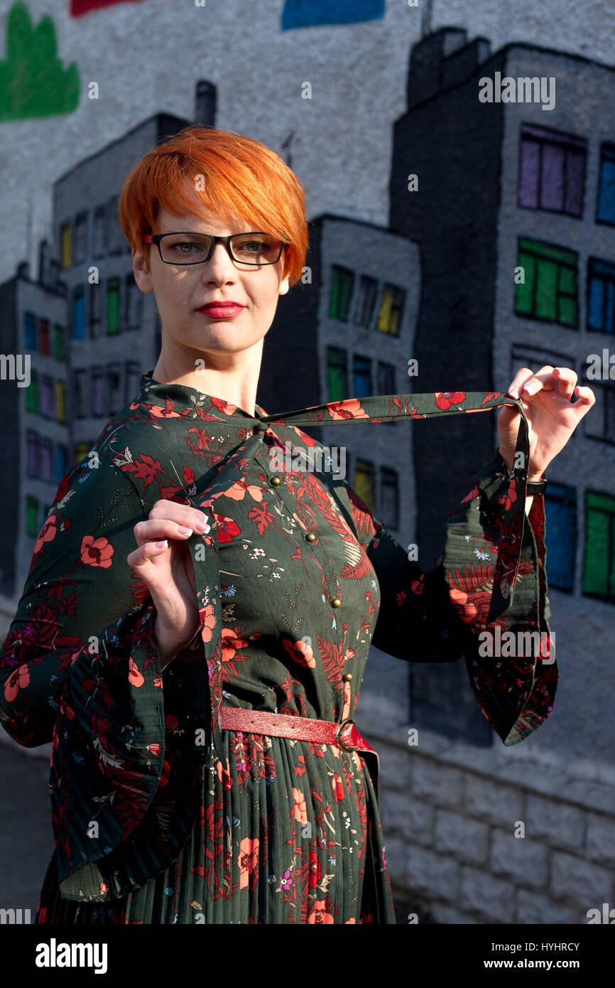 The Girl With Short Red Hair With Glasses Laughs Stock Photo