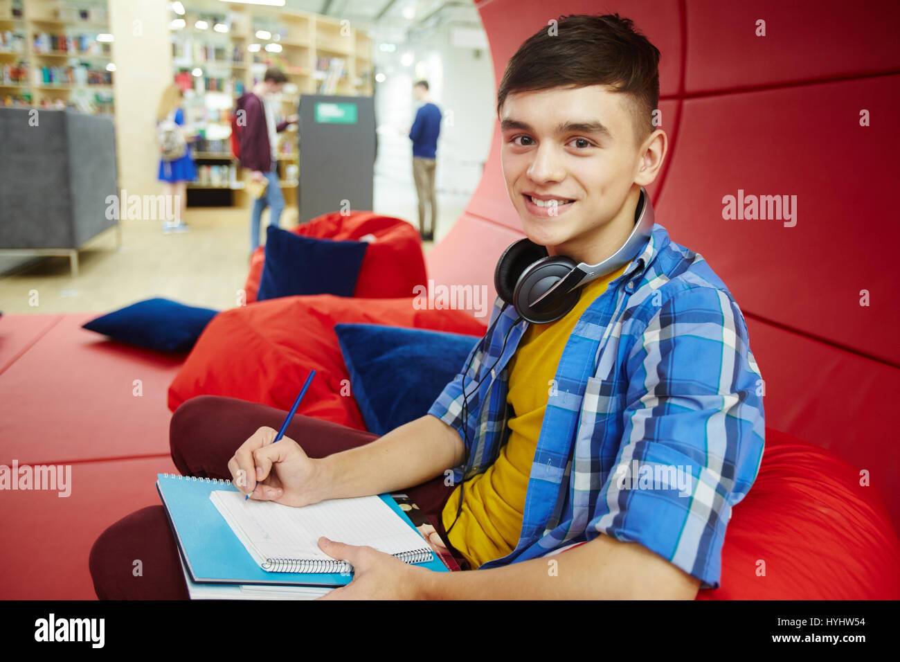 Smiling College Student in Modern Workspace Stock Photo
