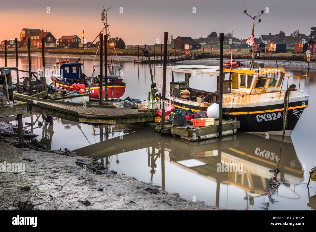 Fishing boats moored alongside the pontoons on Blackshore in Southwold, Suffolk, at dawn in mid March. Stock Photo