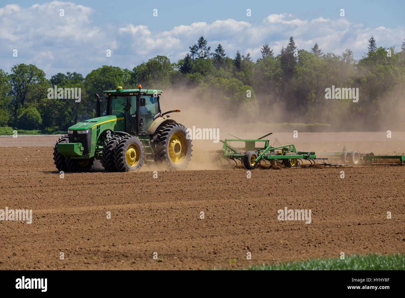 ALBANY, OR - MAY 7, 2015: John Deere commercial tractor plowing a field ...