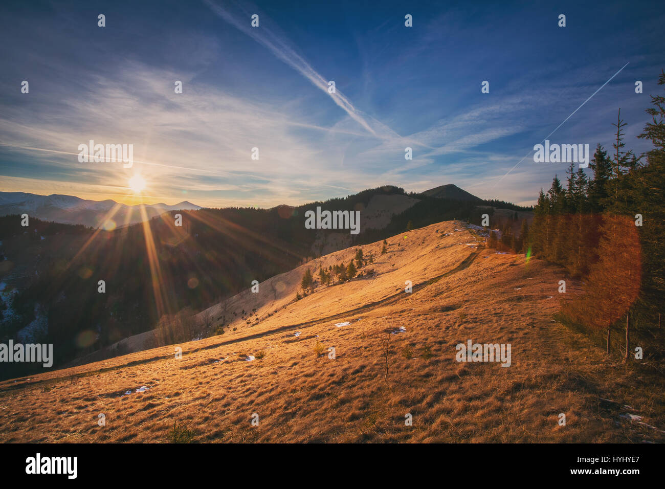 Spring landscape. The sunsets over a mountain range that has snow Stock Photo