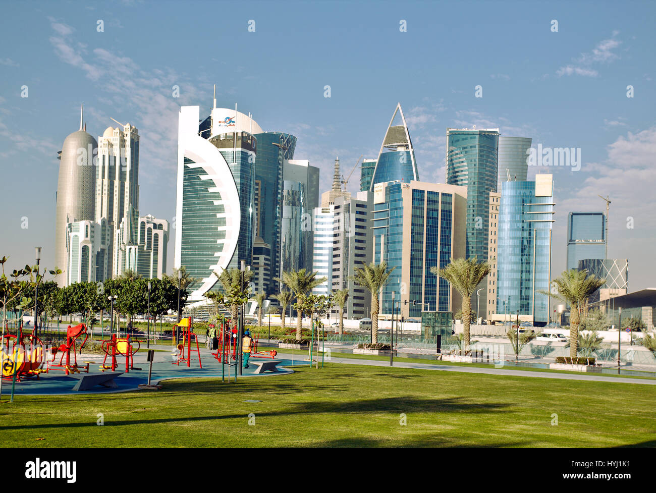 DOHA, QATAR - FEBRUARY 17, 2016: The high-rise district of Doha, seen from the recently completed Hotel Park, with a children's playground in the fore Stock Photo