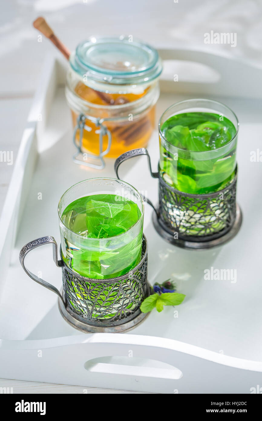 Mint tea with honey in white kitchen Stock Photo Alamy