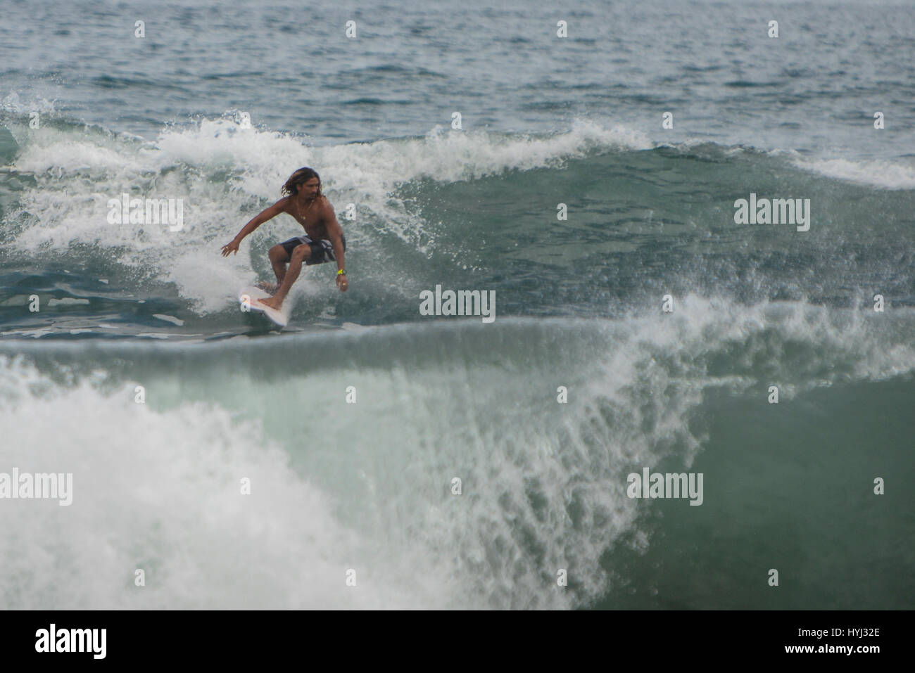 Carlos, 'Cali', Muñoz surfs the waves at Playa Hermosa on Costa Rica's Pacific Coast. Stock Photo