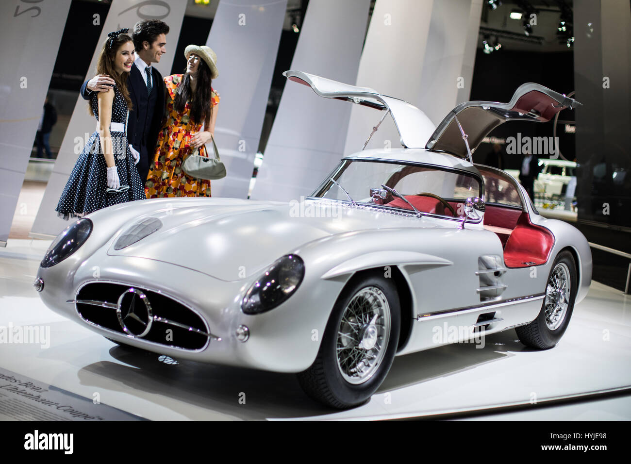 Essen, Germany. 5th Apr, 2017. The models Marcel (L-R), Vivien and Maret stand adjacent to Mercedes Benz 300 SLR 'Uhlenhaut-Coupe' (W 196 S) from 1955 at the Techno Classica for 'Oldtimers' and 'Youngtimers' in Essen, Germany, 5 April 2017. The world trade fair will take place from the 5th to the 9th April. Photo: Marcel Kusch/dpa/Alamy Live News Stock Photo
