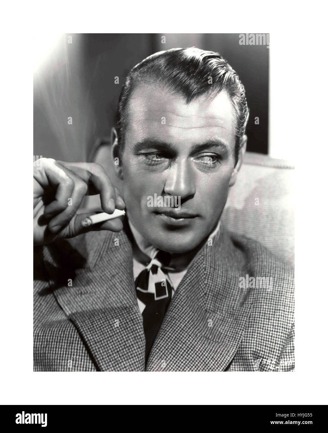 GARY COOPER ACTOR Hollywood film still of Gary Cooper (born Frank James Cooper; May 7, 1901 - May 13, 1961)  an American film actor known for his natural, authentic, and understated acting style and screen performances. He was  a very popular handsome young man Stock Photo
