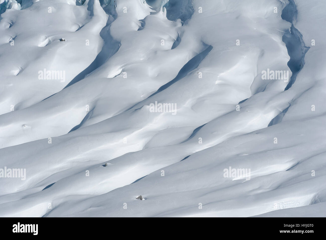 Close-up of Glacier d'Argentiere with snow covered crevasses and seracs formed while flowing down the valley in winter. Stock Photo